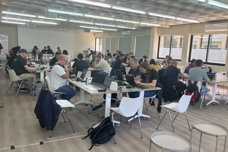 Drupal Dev Days Athens 2026 Contribution Day room with developers working at long tables